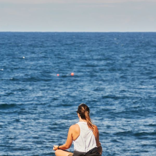 Woman practicing a calm breathing exercise outdoors.